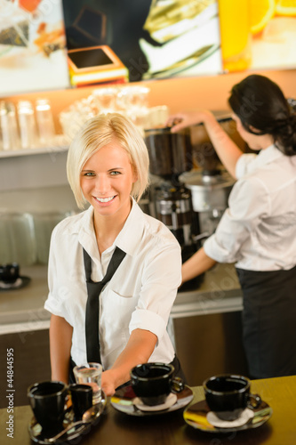 Photo: Waitress serving coffee cups making espresso woman Waitress serving coffee cups making espresso woman