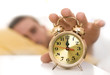 Man turning the alarm clock off