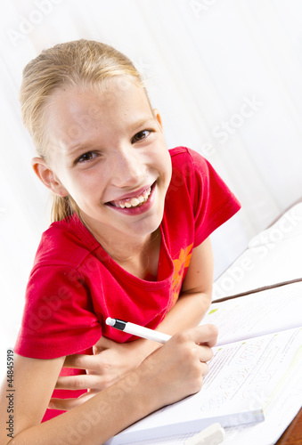Photo: Girl doing her homework Girl doing her homework