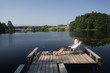 Young businessman sitting on pier at lake relaxing