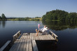 Young businessman sitting on pier at lake with American flag
