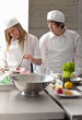 Trainee chefs working together in commercial kitchen