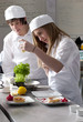 Trainee chefs working together in commercial kitchen