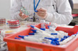 Technician swabbing petri dish in laboratory