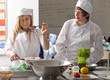 Trainee chefs working together in commercial kitchen