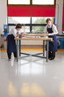 Students in woodworking class working on model airplane together