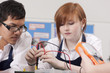 Students working on electronic device in vocational class together