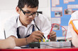 Students working on electronic device in vocational class together
