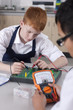 Students working on electronic device in vocational class together