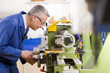 Metalworker using lathe in workshop