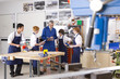 Teacher talking to students in vocational classroom