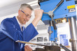 Metalworker using drill in workshop