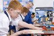 Students cutting wood in woodworking class