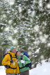 Couple backpacking in snowy woods