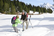 Couple hiking on trail in snow covered wilderness