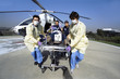 Photo : Doctors and paramedics rushing patient on gurney from emergency airlift helicopter Doctors and paramedics rushing patient on gurney from emergency airlift helicopter