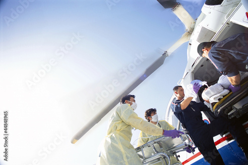 Photo: Doctors and paramedics transferring patient from emergency airlift helicopter Doctors and paramedics transferring patient from emergency airlift helicopter