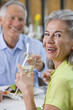 Portrait of happy couple drinking wine at restaurant