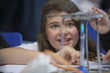 Close up of girl experimenting with Bunsen burner in science class