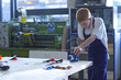 Boy using saw in school workshop