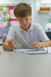 Boy painting in classroom