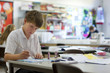 Boy painting in classroom