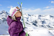 Woman kissing skis on snowy mountain