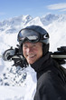 Foto: Close up portrait of smiling senior man with skis on snowy mountain top Close up portrait of smiling senior man with skis on snowy mountain top