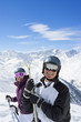 Foto: Portrait of smiling senior couple wearing ski goggles and holding skis on snowy mountain Portrait of smiling senior couple wearing ski goggles and holding skis on snowy mountain