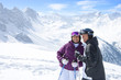 Foto: Smiling senior couple with ski poles on snowy mountain Smiling senior couple with ski poles on snowy mountain