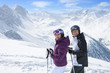 Foto: Portrait of smiling senior couple with ski poles on snowy mountain Portrait of smiling senior couple with ski poles on snowy mountain