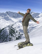 Photo: Portrait of smiling senior man standing with arms outstretched on rock on snowy mountain Portrait of smiling senior man standing with arms outstretched on rock on snowy mountain