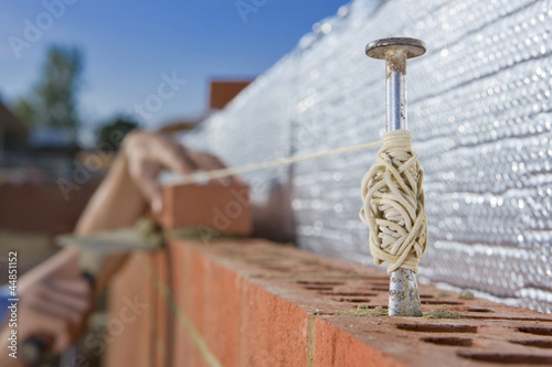 Photo: Bricklayer laying brick wall Bricklayer laying brick wall