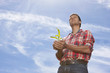 Farmer cupping corn seedling