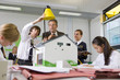 Photo: Students and teacher experimenting with solar panel and light in science class Students and teacher experimenting with solar panel and light in science class