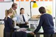 Photo: Teacher and students in school uniforms with wind turbine and solar panel models in science class Teacher and students in school uniforms with wind turbine and solar panel models in science class