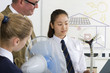 Photo: Teacher and students in school uniforms with wind turbine model in science class Teacher and students in school uniforms with wind turbine model in science class