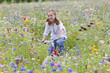 Portrait of smiling girl riding bicycle in wildflower field