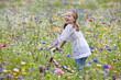 Smiling girl riding bicycle in wildflower meadow