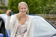 Excited woman holding keys to new car
