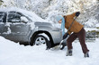 Photo: Woman shoveling snow near car Woman shoveling snow near car