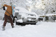 Photo: Woman shoveling snow near car Woman shoveling snow near car