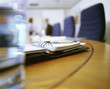 Foto: Close up of day planner on conference room in office Close up of day planner on conference room in office