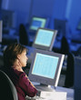 Photo: Businesswoman sitting at desk working late and rubbing neck Businesswoman sitting at desk working late and rubbing neck
