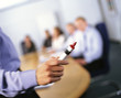 Business people watching co-worker giving presentation holding red marker