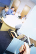 Late business person entering meeting in office conference room
