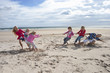 Kids playing tug-of-war on sunny beach