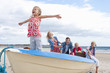 Family in boat on beach