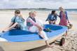 Happy family in boat on beach