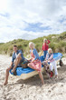 Portrait of smiling family sitting in boat on beach